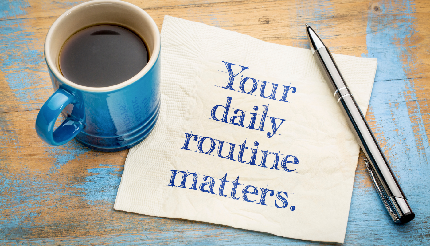 "your daily routine matters" written on a tissue next to a cup of coffee to learn and practice english