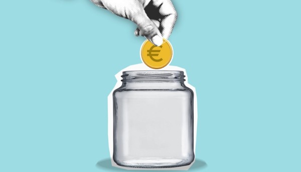 hand putting a coin in a jar for study abroad budget