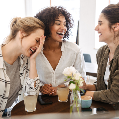 friends laughing at a funny british jokes